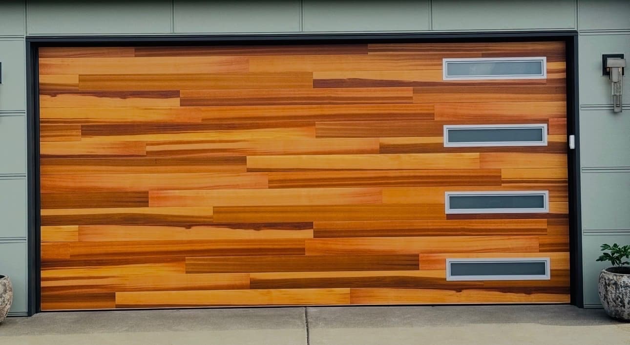 Cedar plank insulated garage door with a vertical stack of windows
