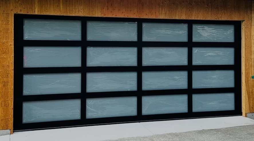 Full view aluminum-frame garage door with frosted glass panels