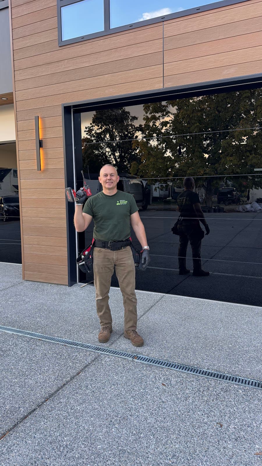 Technician after completing garage door installation