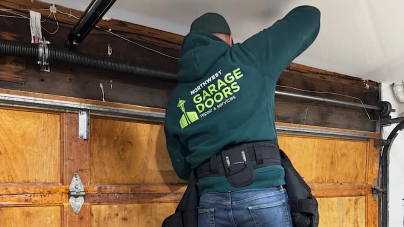 Northwest Garage Doors technician inspecting garage door