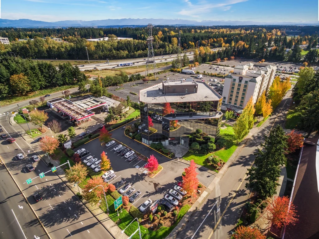 A clear view of a commercial area in Federal Way, with autumn foliage and a modern office building.